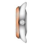 Close-up of a watch with a rose gold and silver band on a white background